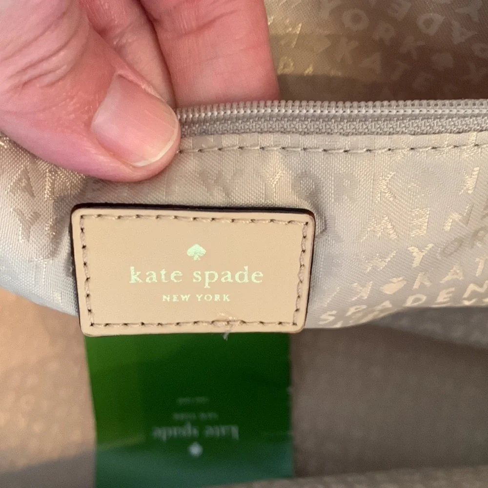 Kate Spade cream colored cloth tote with green leaf pattern.